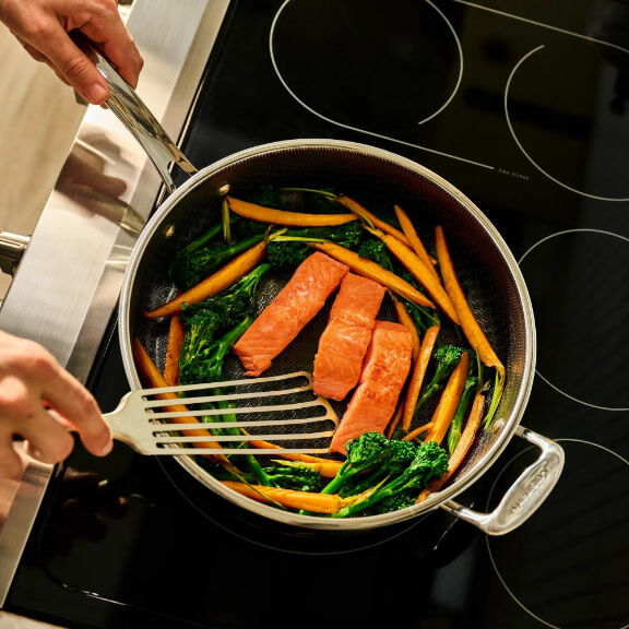 Man Cooking Steak in Pan
